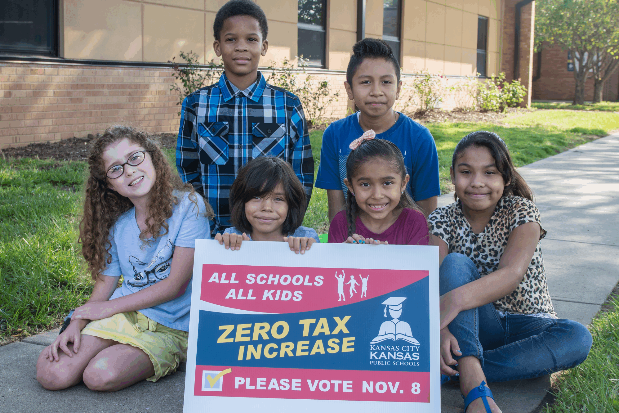 cropped-Contingency-Marketing-Plan-Image-2.png Group of young students outside holding a sign to vote for a zero tax increase for Kansas City Kansas Public Schools